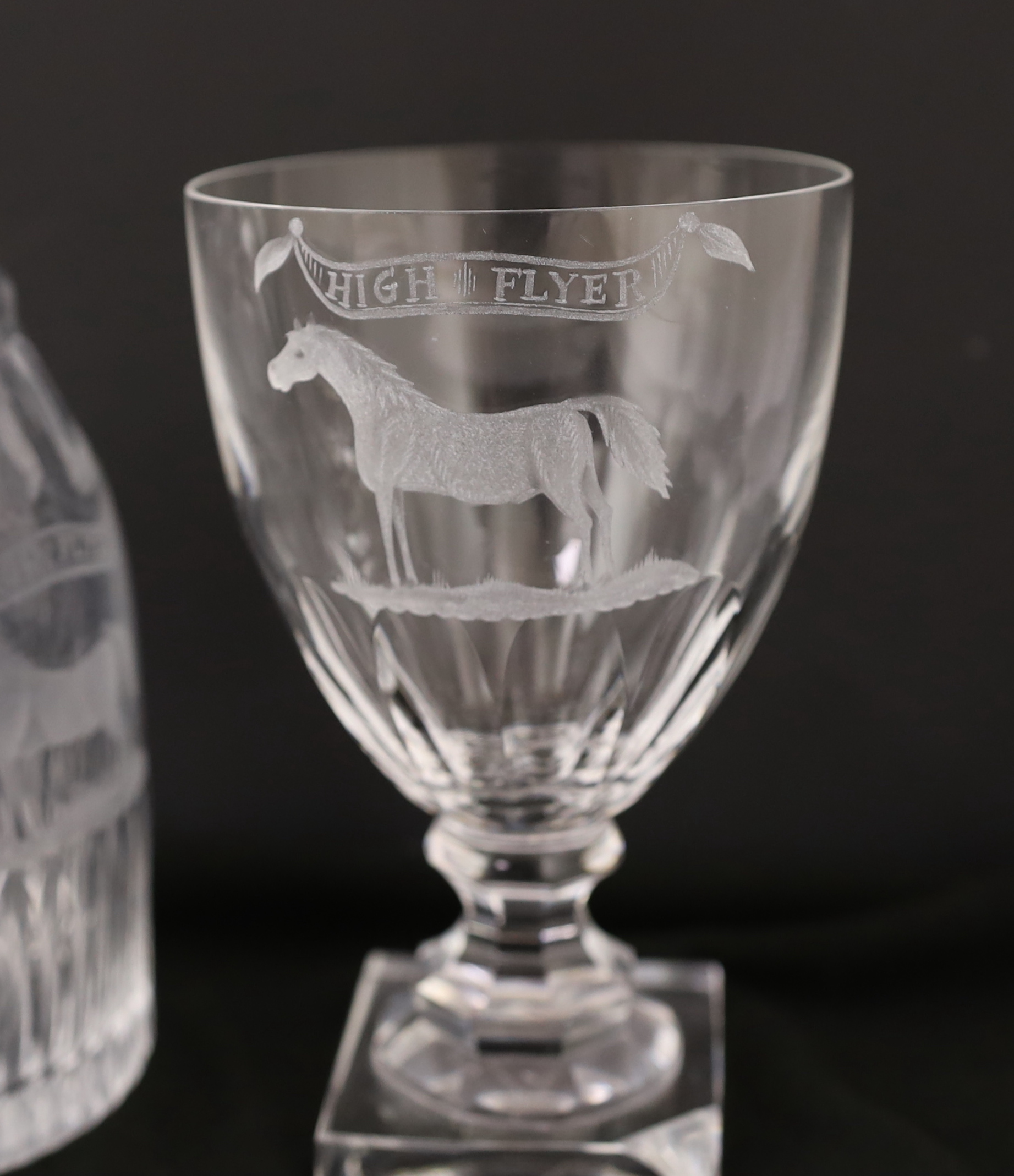 A suite of George III style drinking glassware, consisting, of a pair of decanters and stoppers and five square based rummers, each engraved an image of a racehorse and inscription ‘’High Flyer’’. c.1790. Note: Highflyer